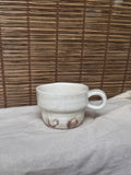 Maori White Glazed Stoneware Mug — Looped Handle, Stamped Maker's Mark, Iron-Spot Accents