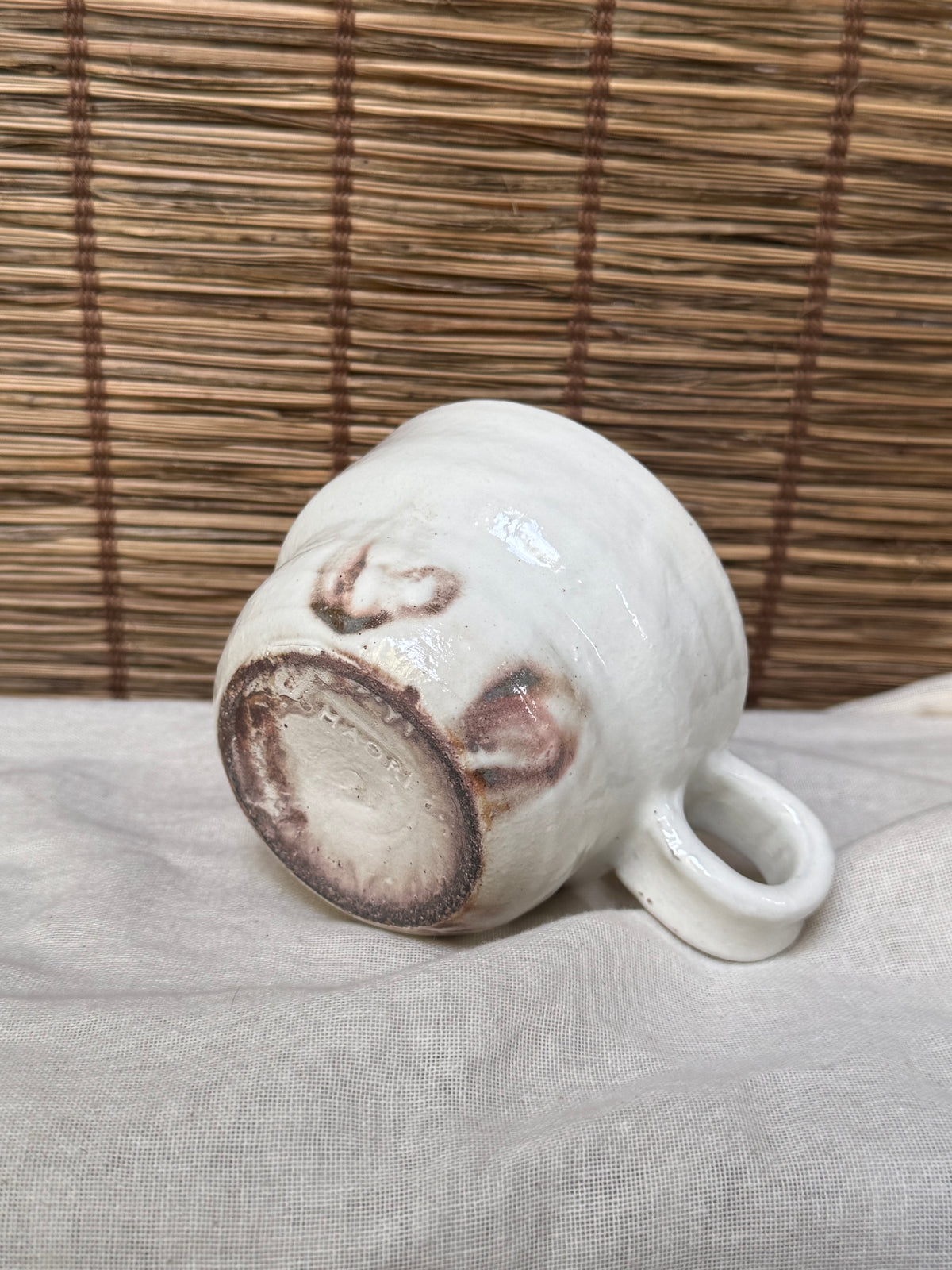 Maori White Glazed Stoneware Mug — Looped Handle, Stamped Maker's Mark, Iron-Spot Accents
