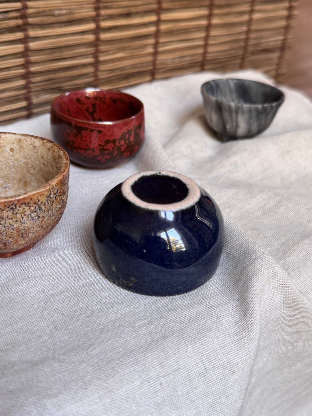 Four Mismatched Guinomi Sake Cups — Cobalt Blue, Crackled Ivory, Marbled Grey, Oxblood Speckle