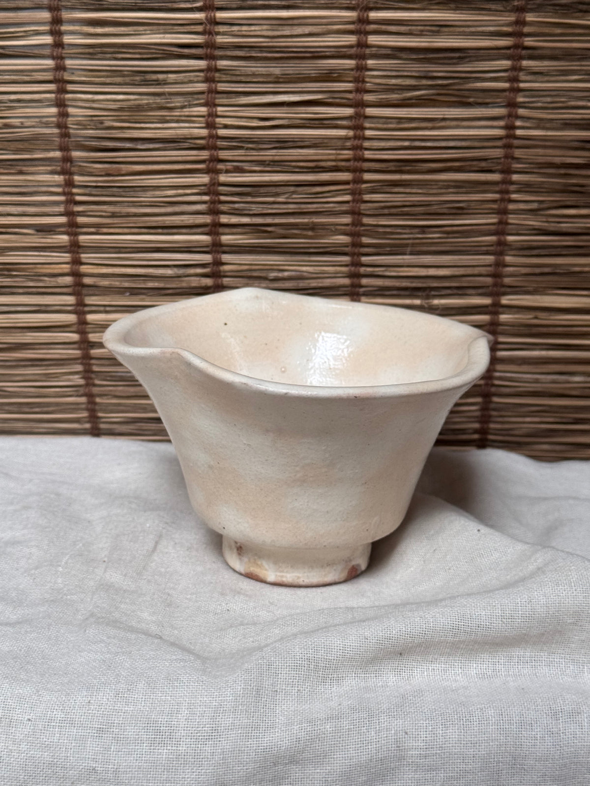 Hagi Ware Trumpet Cup — Wave-Rim Form, Ivory Glaze with Iron Blush