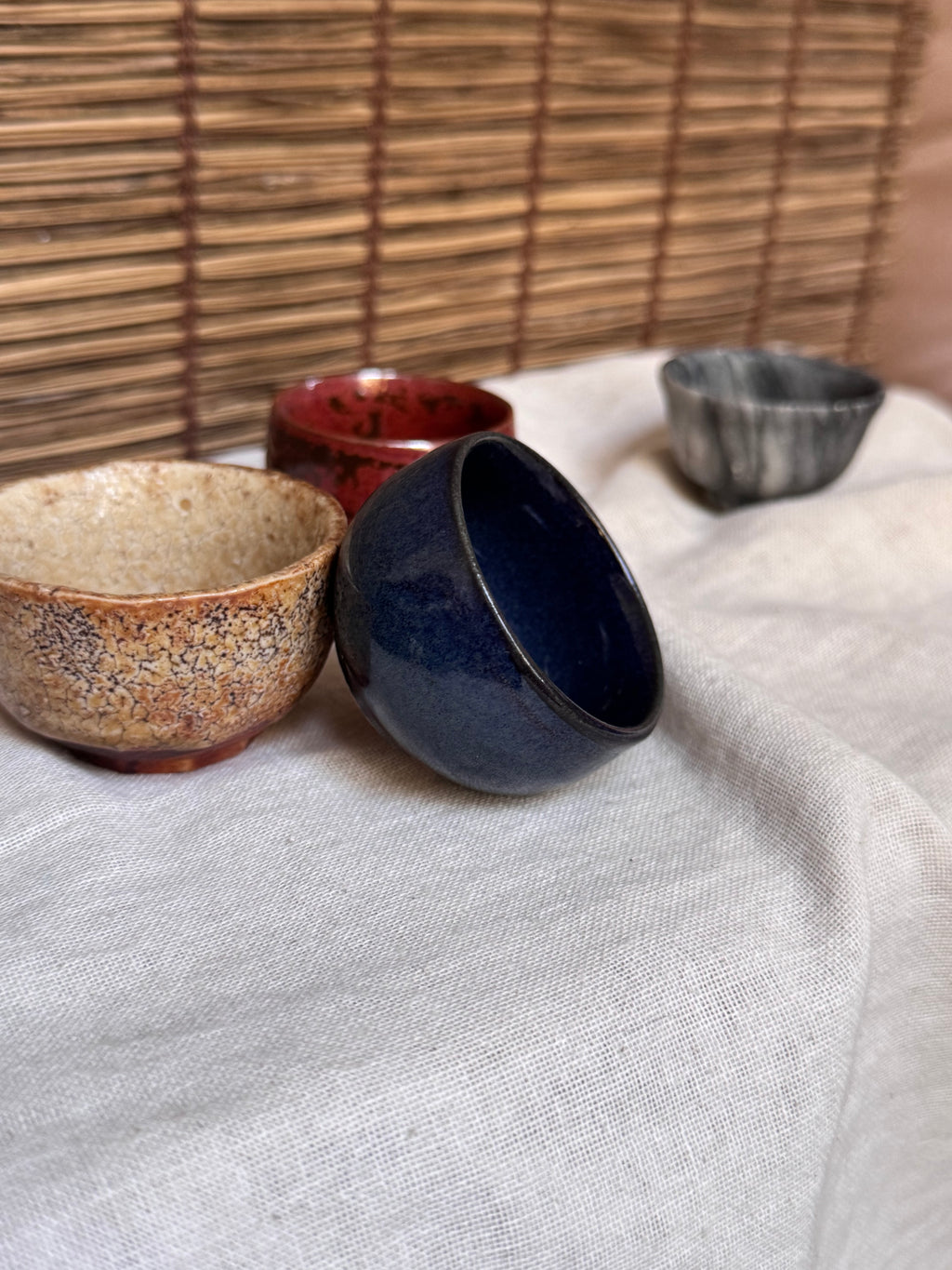 Four Mismatched Guinomi Sake Cups — Cobalt Blue, Crackled Ivory, Marbled Grey, Oxblood Speckle