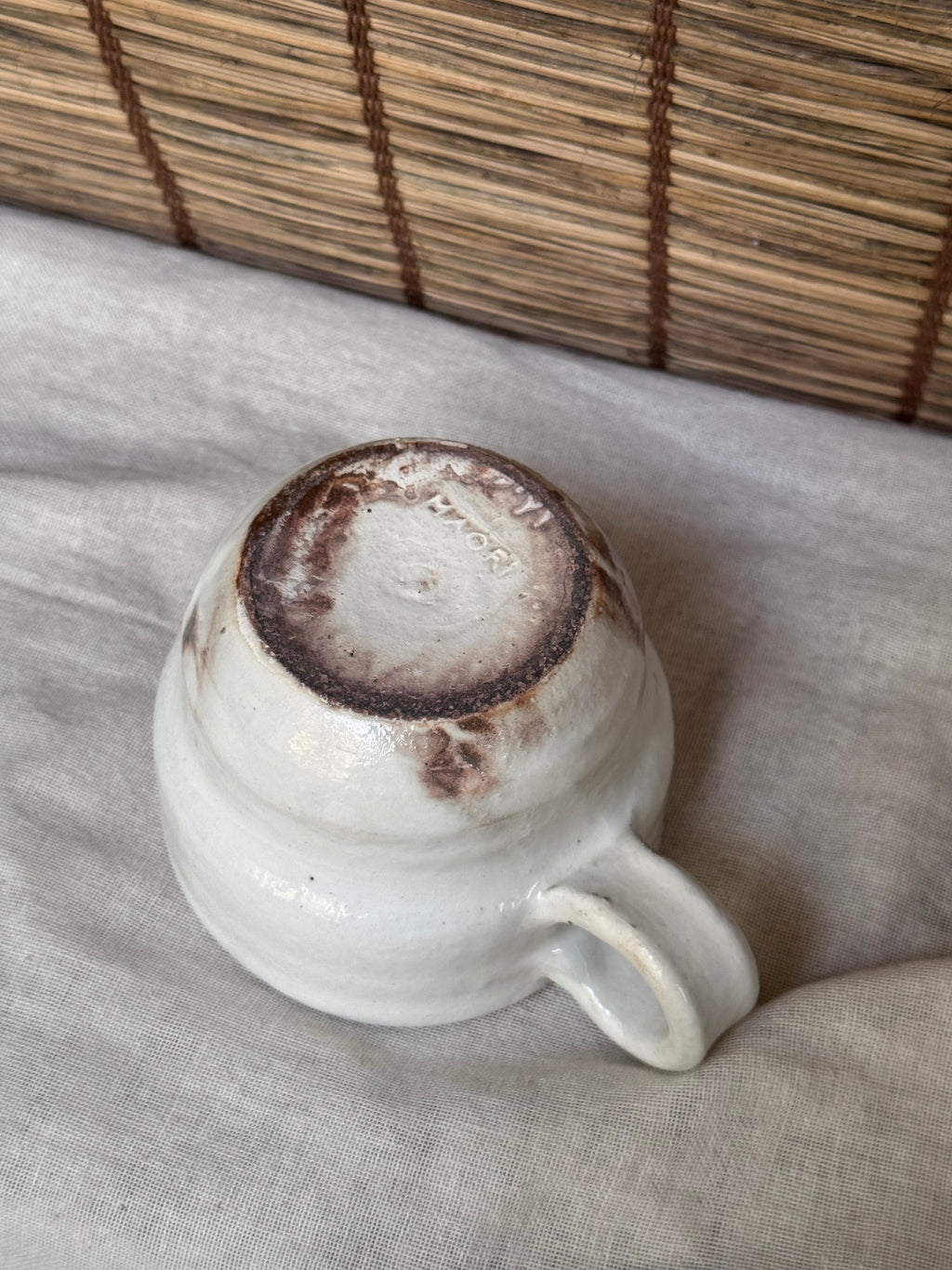 Maori White Glazed Stoneware Mug — Looped Handle, Stamped Maker's Mark, Iron-Spot Accents