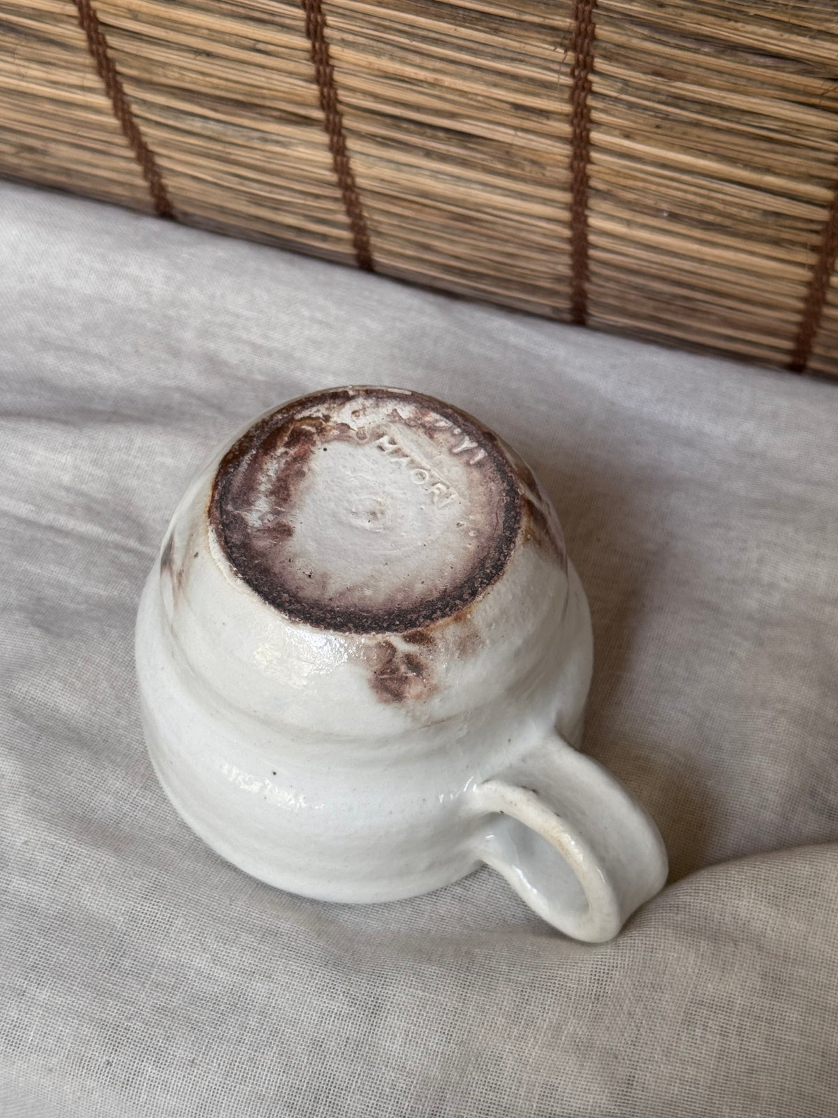 Maori White Glazed Stoneware Mug — Looped Handle, Stamped Maker's Mark, Iron-Spot Accents