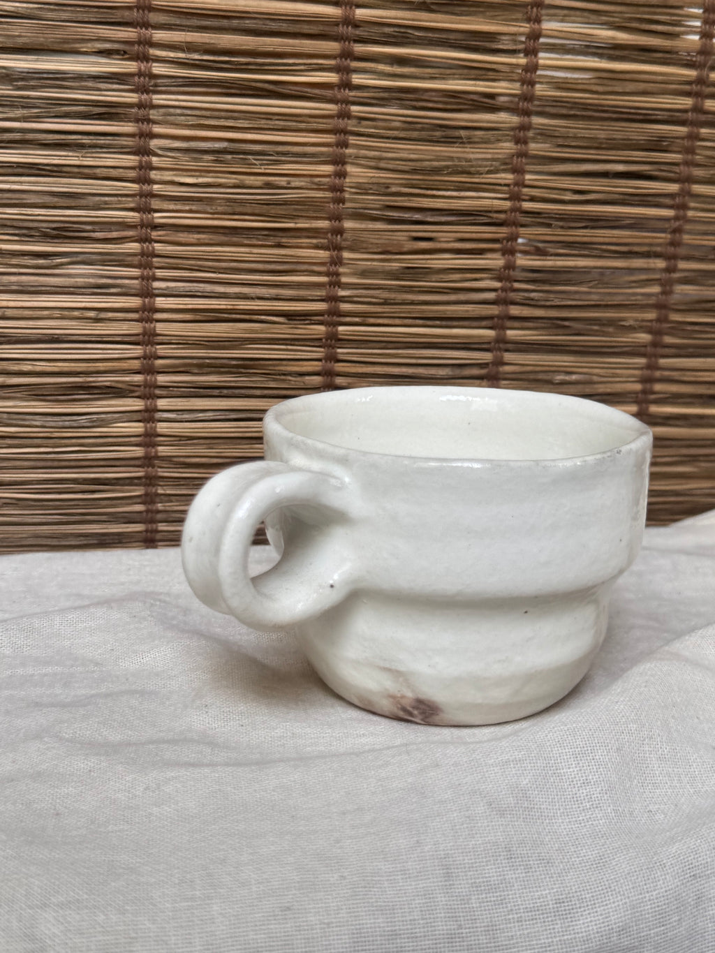 Maori White Glazed Stoneware Mug — Looped Handle, Stamped Maker's Mark, Iron-Spot Accents