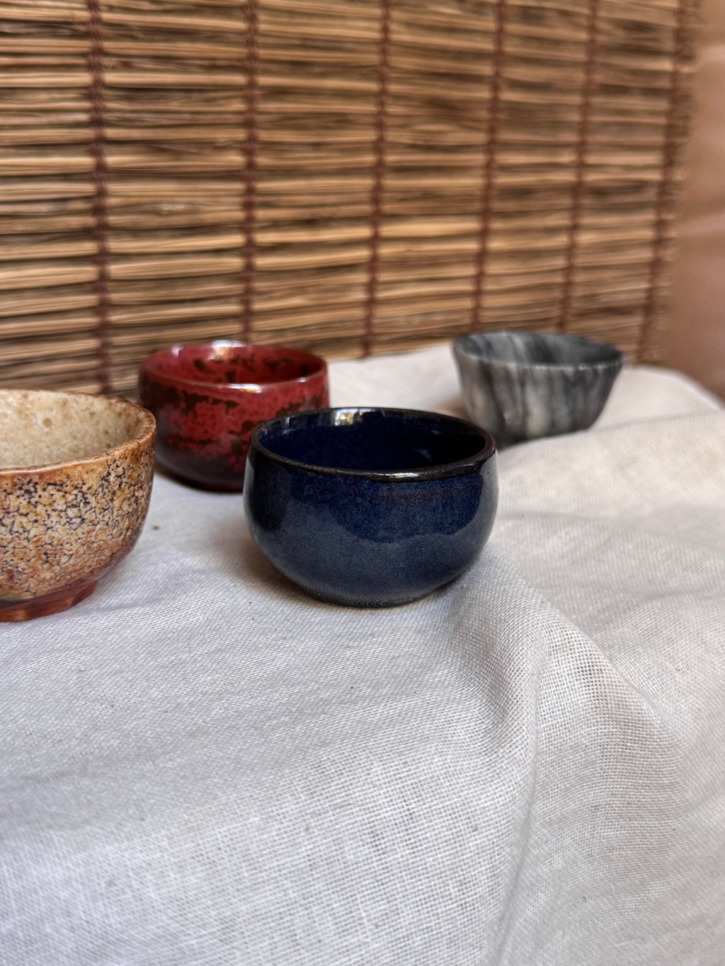 Four Mismatched Guinomi Sake Cups — Cobalt Blue, Crackled Ivory, Marbled Grey, Oxblood Speckle